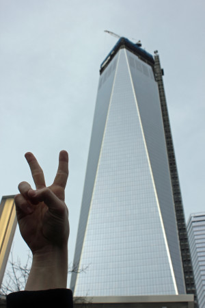 Junior Carter Dahl throwing up a peace sign in front of the Freedom Tower. 