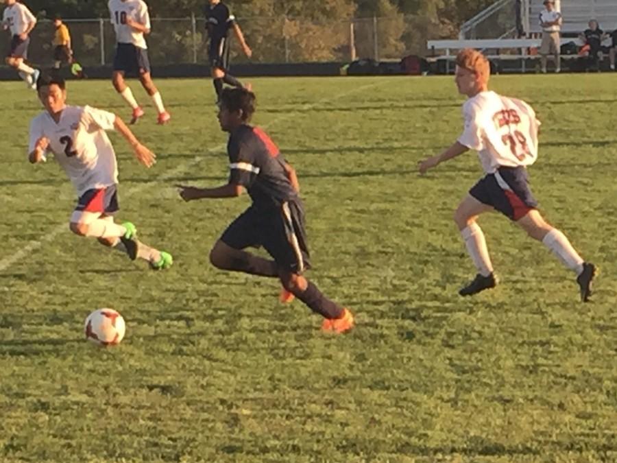 (L-R) Lay Wah and Noah Karge chase down a St. Peter Attacker.