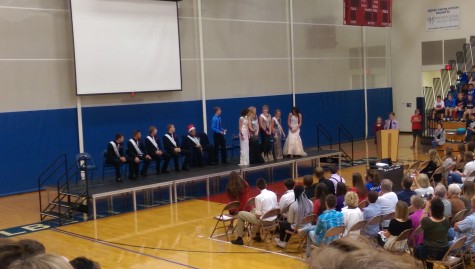 Last year's Homecoming King, Connor Larson prepares to crown Calin Adams as Homecoming Queen during the coronation ceremony. This year's ceremony was held in the ALHS gym instead of the auditorium where it had been held in past years.