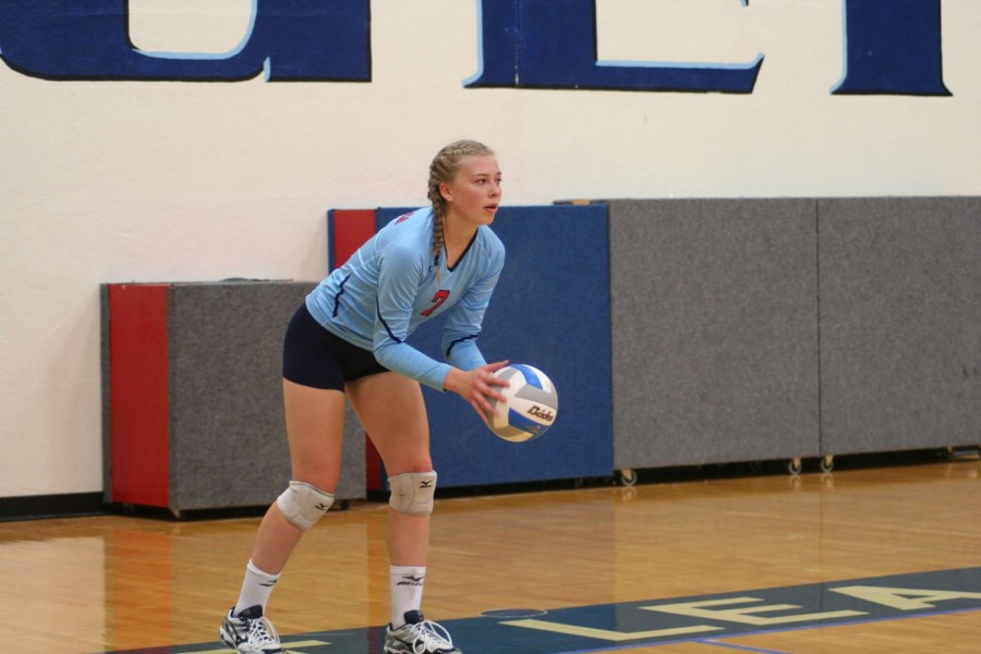 Camryn Keyeski (11) prepares to serve the ball