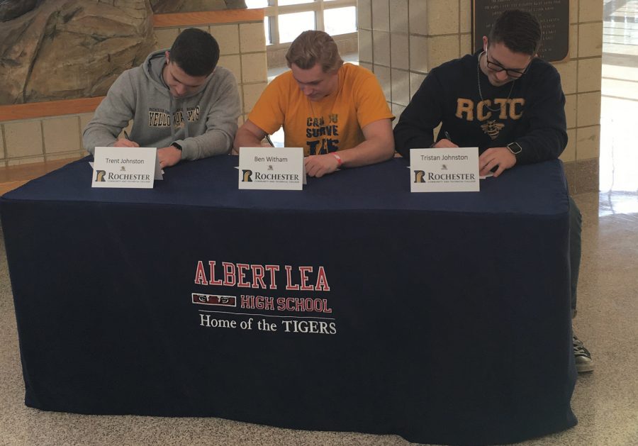 Seniors Trent Johnston, Benjamin Witham and Tristan Johnston sign their letters of intent to play football at Rochester Community and Technical College in Rochester. The boys have been playing football for many years for the Albert Lea Tigers. Photo Submitted