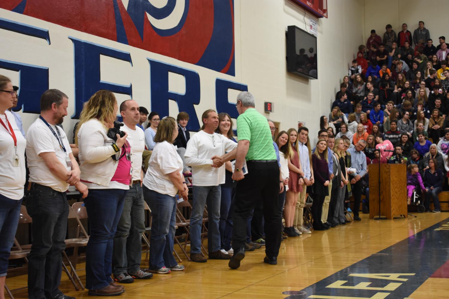 Social studies teacher Steve Cunningham shakes hands with  2007 Inductee Kurt Barickman during the induction ceremony held in the Orrie Jirele Gymnasium. 