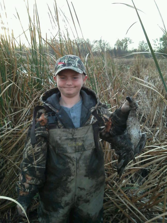 Junior Grant Forman holds his prize after a successful day of hunting.