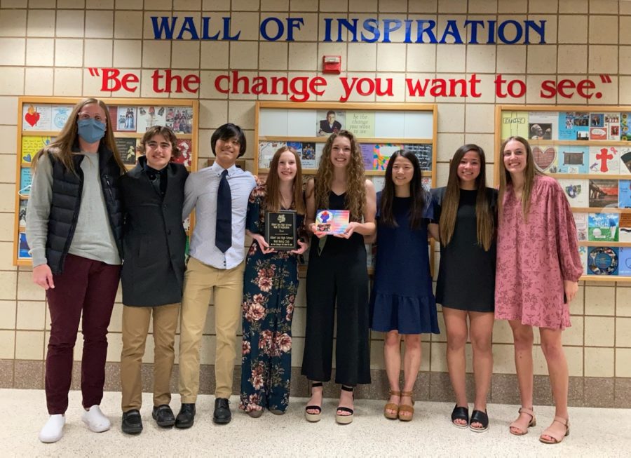 Gina Klennert, Tim Chalmers, Joseph Yoon, Kailey Boettcher, Abby Chalmers, Esther Yoon, Lucy Stay and Taya Jeffrey pose with their tile in front of the wall of inspiration. Many club members attended the event on Monday, April 12 to celebrate the club's tile joining the wall. "I think it's a huge honor for our club," said Chalmers. "It means the world to us to have been chosen even though we are still such a young club. It shows us that our efforts have had an impact on the students and the school, and that's what our goal has been all along."
