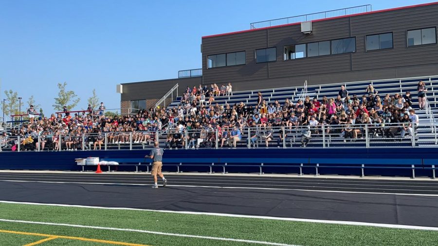 Math teacher Kevin Gentz speaks to the crowd of eighth graders and Link Leaders. The Link Crew event began at the stadium and shifted to the high school as the day progressed. 