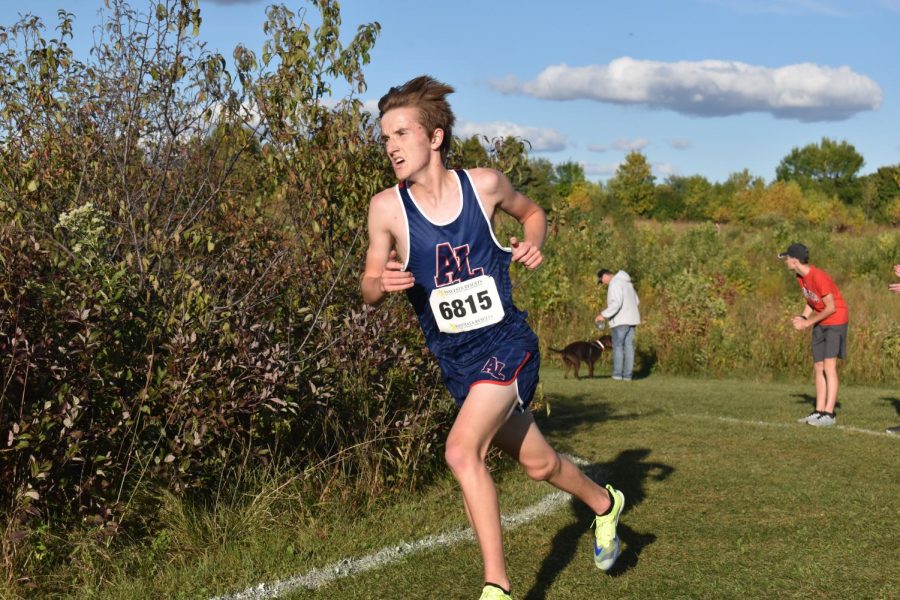 Gavin Hanke a junior turns the corner while running one of the cross country's few home meets. 