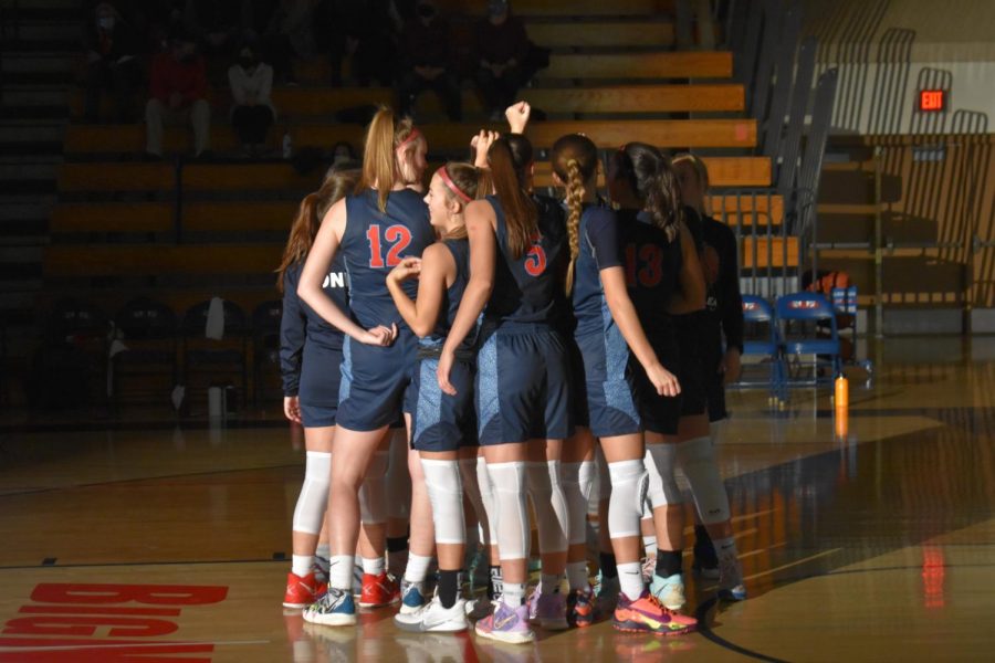 The girls huddle up and cheer after introductions.