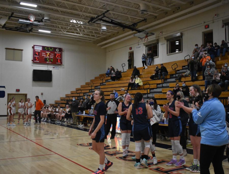 Jeffrey searches the crowd for her parents. Moments after making the free throw that secured her place as the highest scorer in Albert Lea girls basketball history, she was surrounded by her teammates and members of the student section. “I remember immediate hugs from people and Coach Hanson and then finding my parents in the stands and just sending them a heart signal with my hands,” she said.