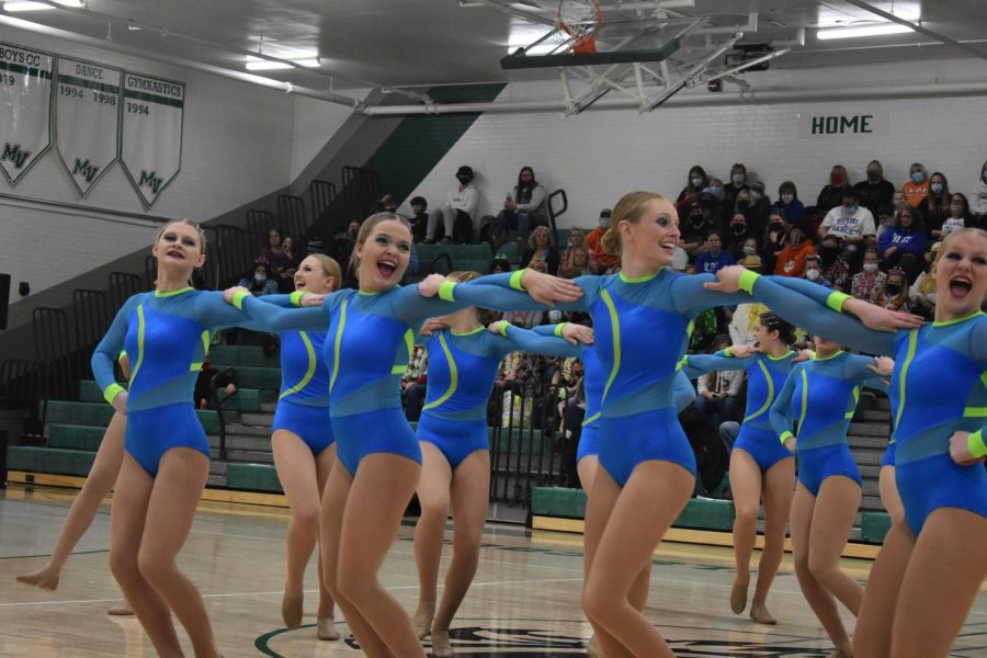 Varsity kick smiles bright during their performance. 