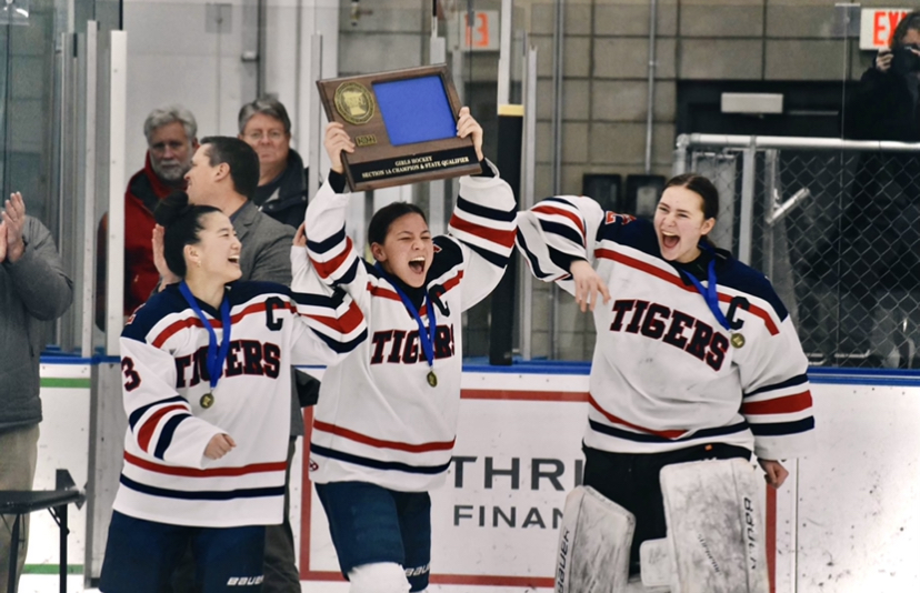 Senior captain Lucy Stay smiles with fellow captains sophomore Rachel Doppelhammer and senior Esther Yoon as she hoists the championship plaque in the air. Last Thursday's win turned one of Stay's greatest aspirations into reality. "State is something I've been dreaming about since I was a little girl, and the fact that we finally made it is insane," she said. "I'm looking forward to everything, but playing at the Xcel Energy Center and making unforgettable memories with my team is what I'm most excited for." 