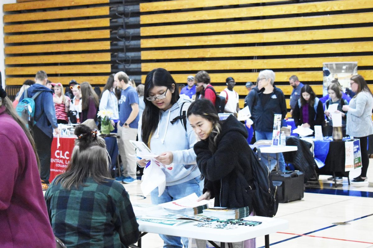 At the College Fair on October 27, Seniors Hsa Paw and Cinderella Say talk with a college advisor.