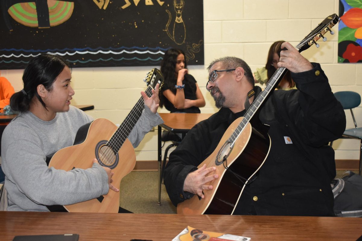 Mr.+Flores+teaching+student+to+play+Guitar