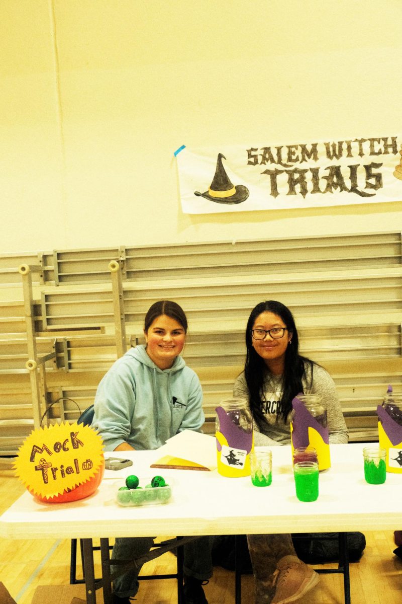 Junior Clara Thompson and Sophomore Nina Zhang working at the Mock Trial booth for the Fall Festival on October 27.