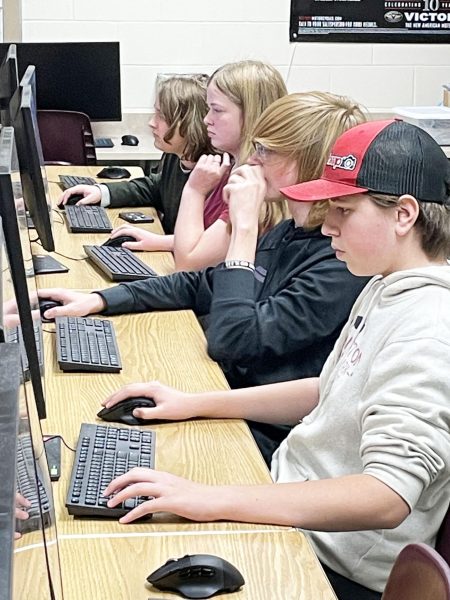 8th Grader Ethan Gordon, 8th Grader Kendal Clarey, Sophomore Parker Munson and Sophmore Levi Monson are practicing in F203 for a League of Legend match. Photo Submitted