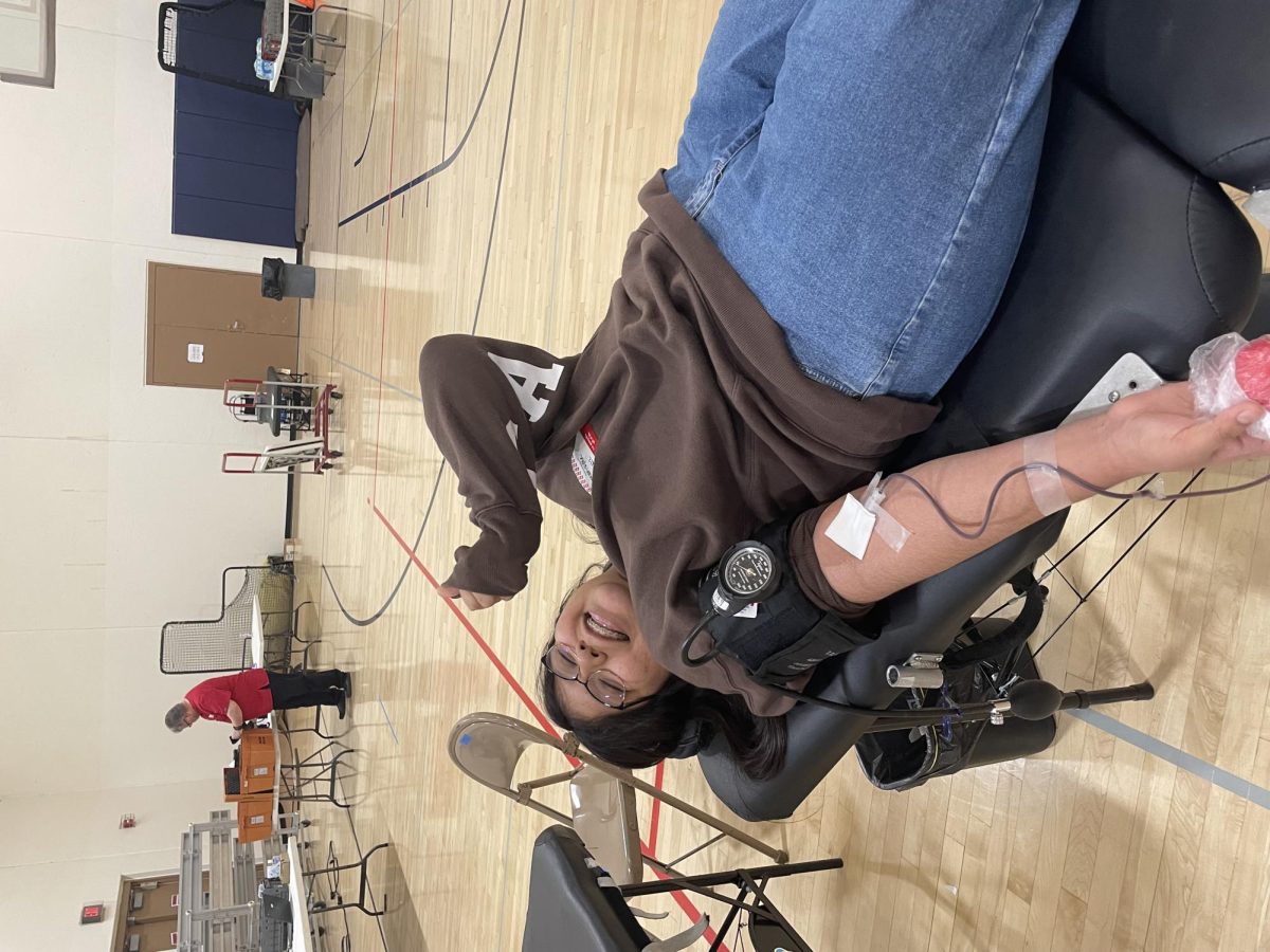 Senior Mariajose Ruiz-Ceronio giving blood