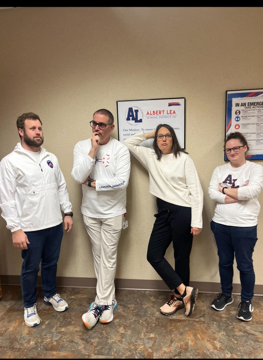  Zachery Luther, Max Jeffrey, Janece Jeffrey, and Brittany Utzka posing in their best "white out" outfits in the hallway before class for Holidaze.