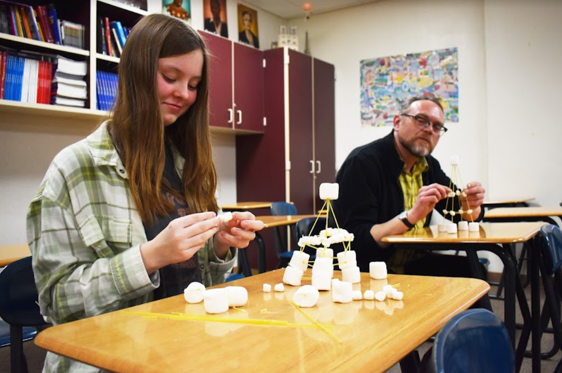 Junior Autumn Warrington and French Teacher Peter Sunnarborg building Eiffel Towers out of spaghetti noodles and marshmallows 
