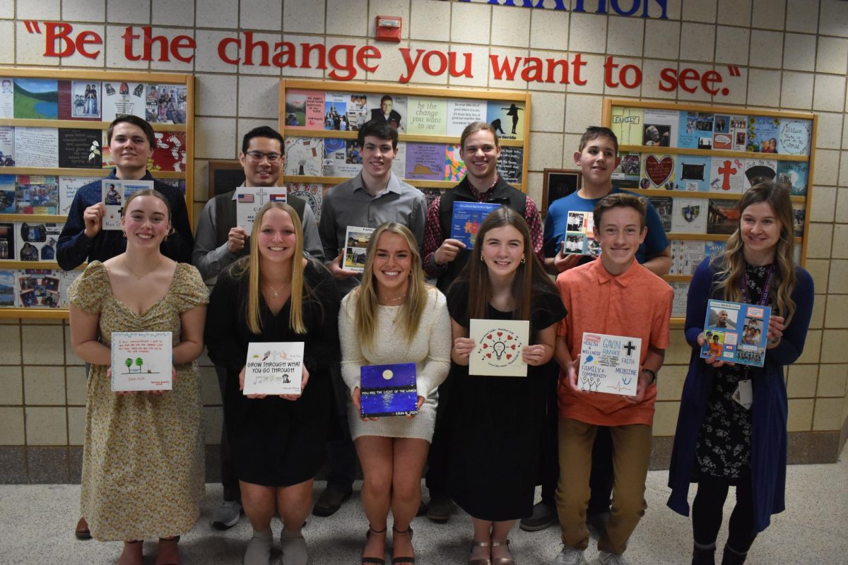 Wall of Inspiration inductees present their tiles in front of The Wall of Inspiration on March 1. The inductees are Max Irvine (12), Dean Sa Taw, Mason Attig (11), teacher Paul Dunn was absent and represented by assistant football coach Cole Janssen, Christian Reichl (12), Hannah Barclay (12), Hannah Veldman (12), Erin Boorsma (12), Evie Dawson (11), 2023 ALHS graduate Gavin Hanke who was represented by his brother Caden Hanke (9) and teacher Angel Welch. This was the 20th anniversary of the Wall of Inspiration. 