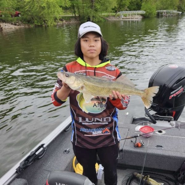 Tenth-grader Taison Salle in his Anglers gear holding a newly caught fish. He said, The Biggest Fish I ever caught was a 42-pound greater amberjack.