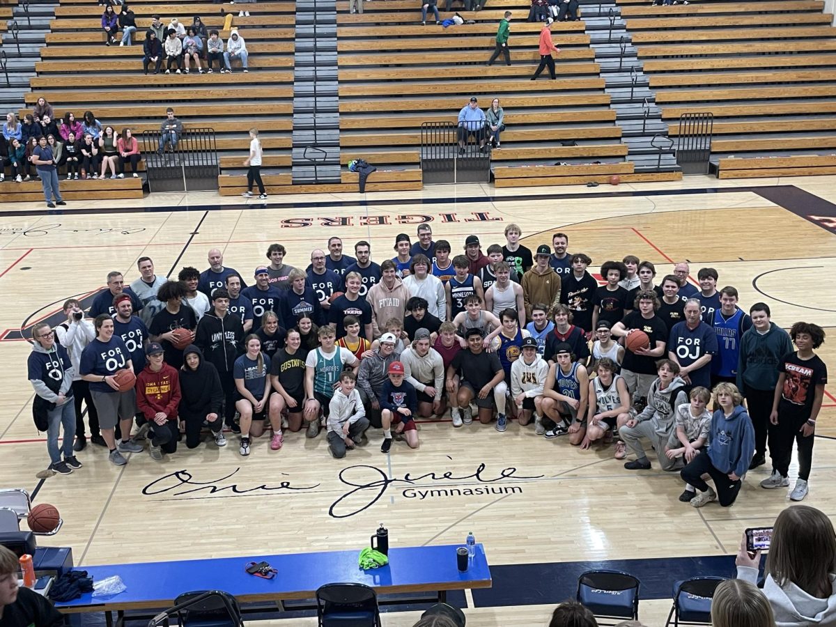 Most of the players, organizers and volunteers who helped raise money for the Orrie Jirele Scholarship pose with his signature in the school's gym. The Night of Fun basketball fundraiser was on March 1st. Sophomores beat the Juniors 84-40. The staff pulled out a last minute win against the Seniors 52-51.