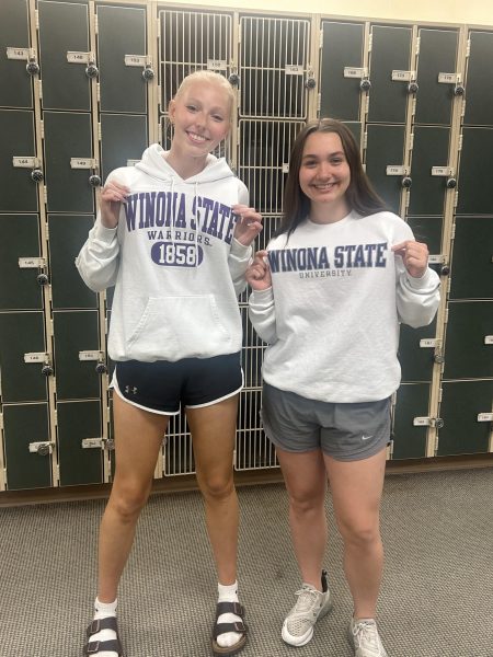 Senior Hannah Estes and Junior Dani Whelan show off the sweaters of the college theyre going to for College and Career Day May 8 2024.