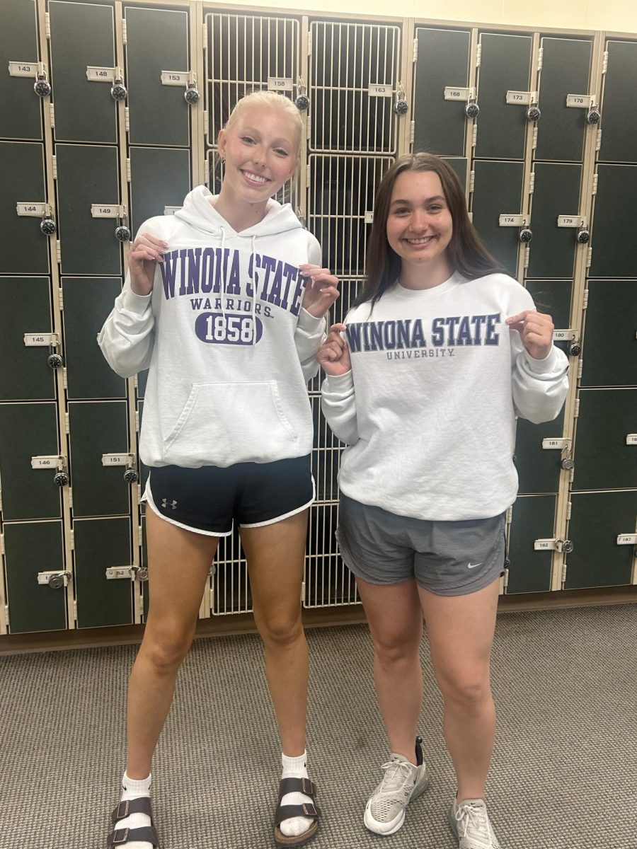 Senior Hannah Estes and Junior Dani Whelan show off the sweaters of the college they're going to for College and Career Day May 8 2024.