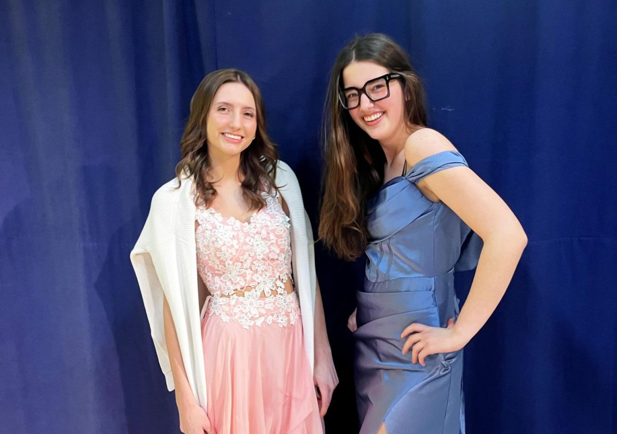Jorja Bolinger (11) and Carlie Ladlie (11) try on prim dresses from the free closet.