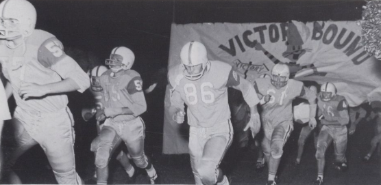 Football players entering the field for Homecoming, 1966. From the 1967 Tiger Yearbook.