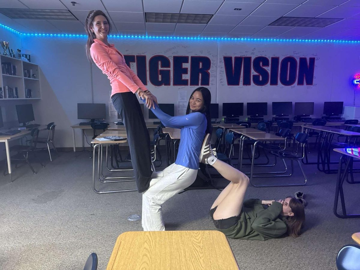 Seniors Jorja Bolinger, Kae Bee and Emma Weckwerth doing yoga.