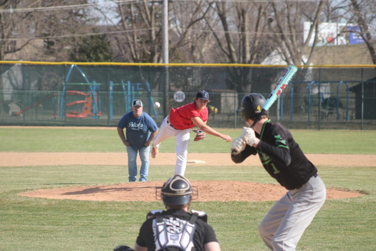 Sam McGill (12) pitching in the Boys Baseball team's first game of 2026 on March 31st.