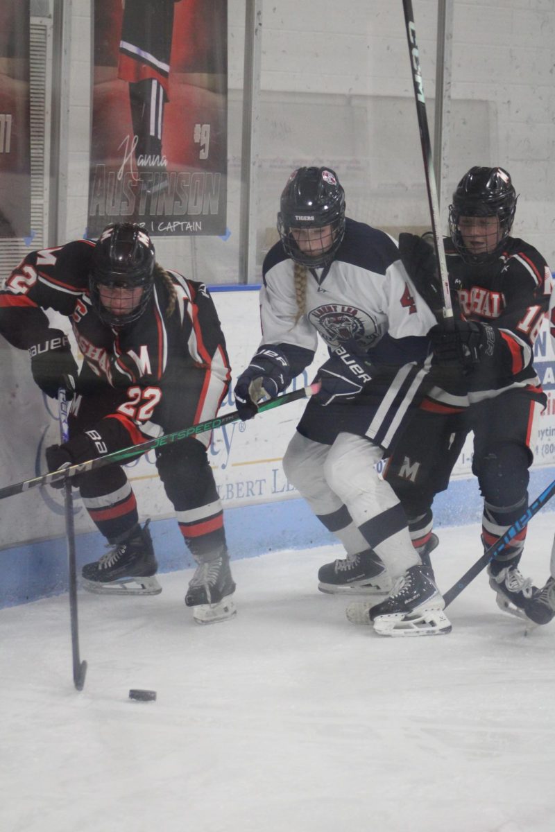 Sydney Kolker (11) attempting to block the rival team, Marshall, from the hockey puck at the girls hockey game on November 13th.