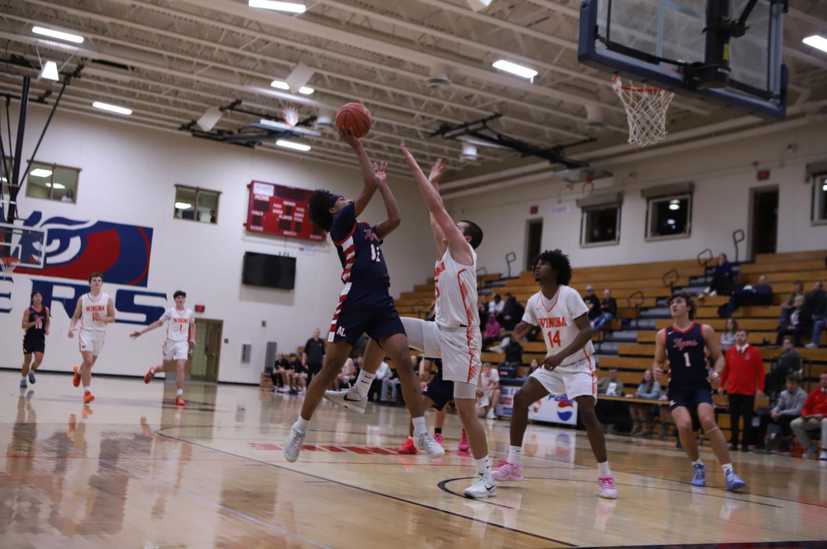 Marques Jeffers-Joseph (11) throwing a shot in the boys basketball game against Winona on December 4th.