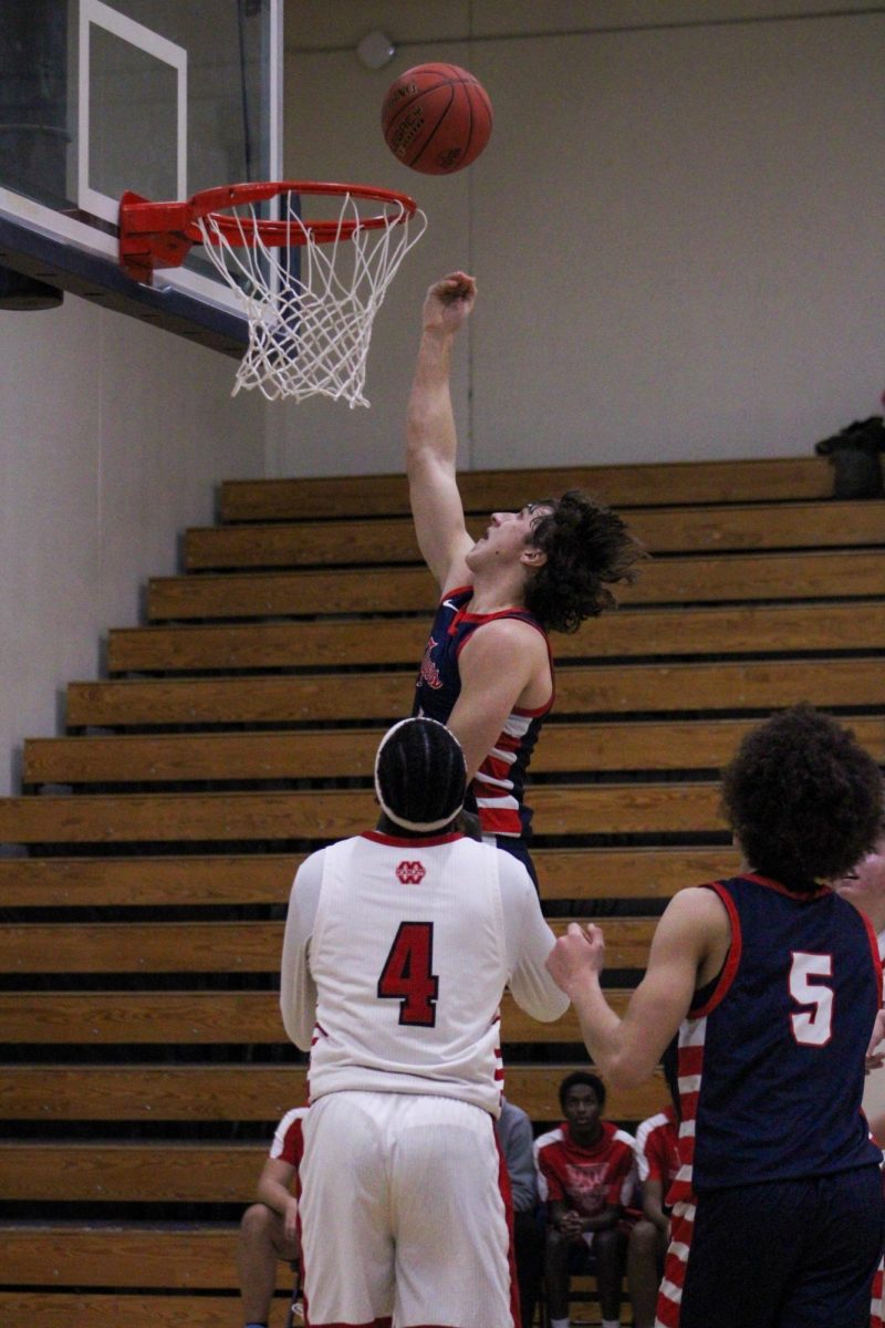 Carter Conn (12) shooting a basket in the Boys Basketball game against Mankato West on January 8th. 