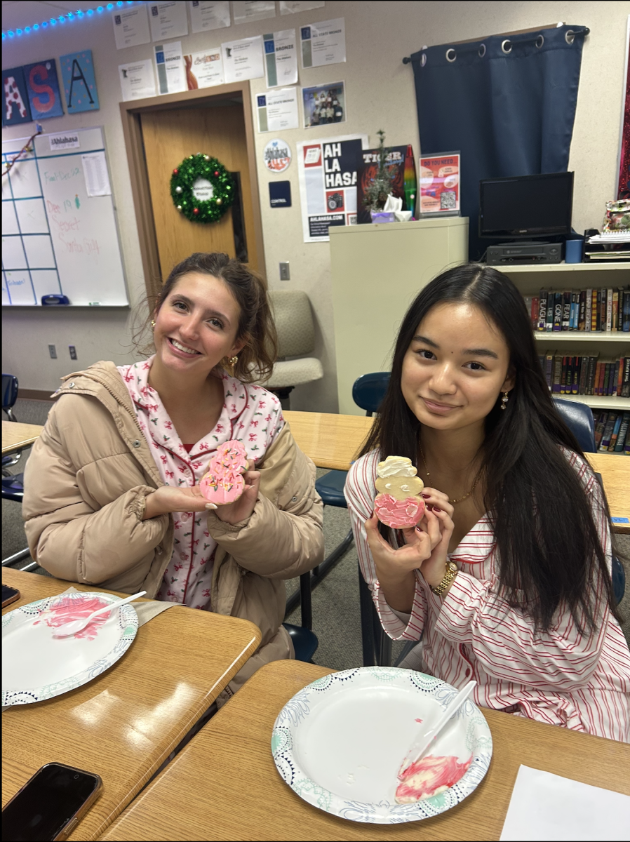 Staff members Kae Bee (12) and Jorja Bolinger (12) showing off their cookie designs. 