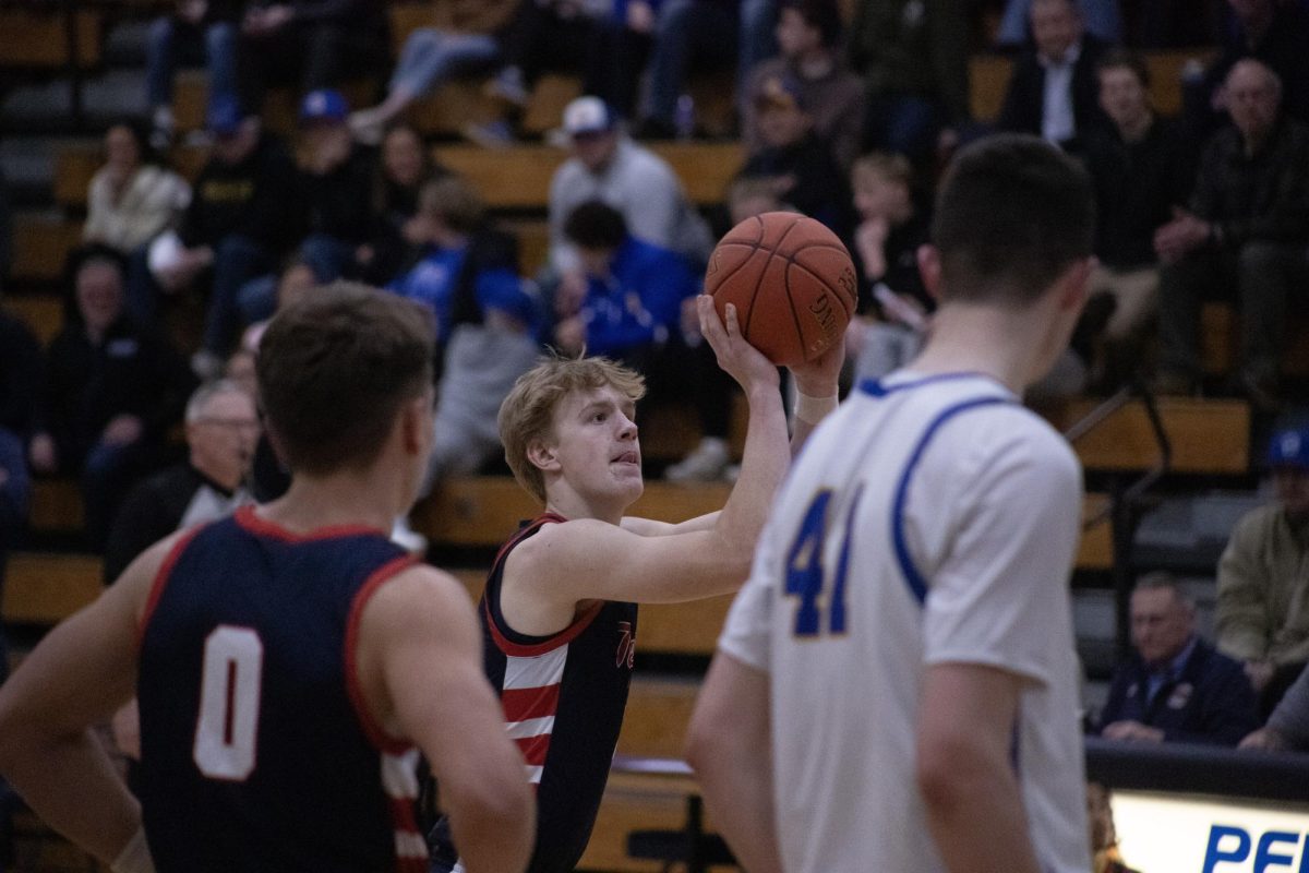 Cooper Kermes (12) shooting a basket in the Boys Basketball game on March 3rd.